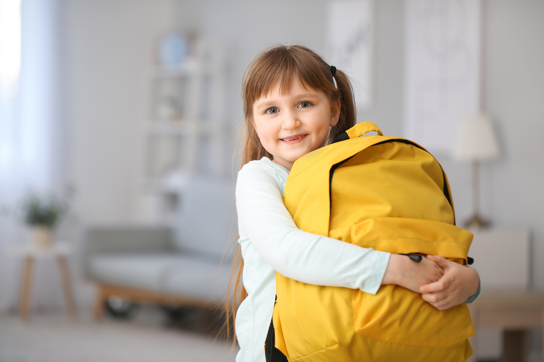 Little Schoolgirl with Backpack at Home